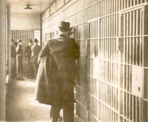 Stenographer Edna Davis Proctor and police officials interview the gunman at the Ohio Penitentiary. 
